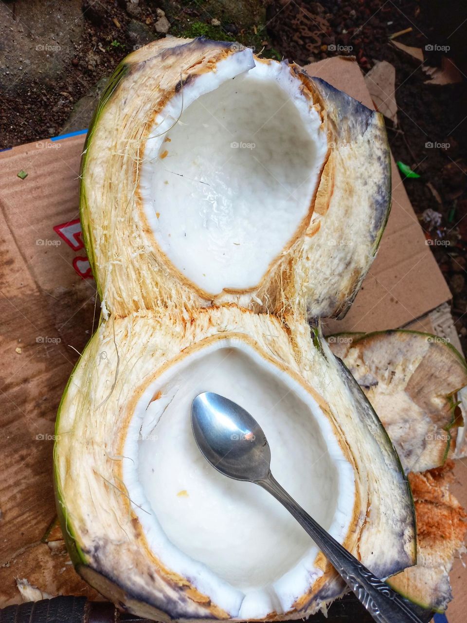 Green coconut is being peeled or water is being taken out
