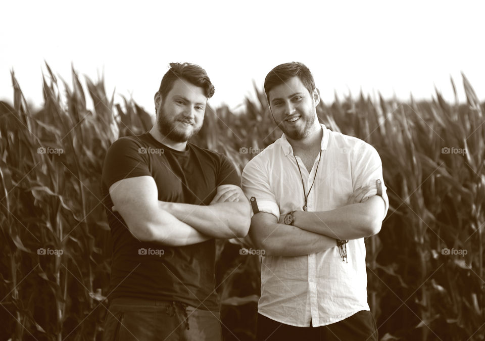 Two brothers on corn field background