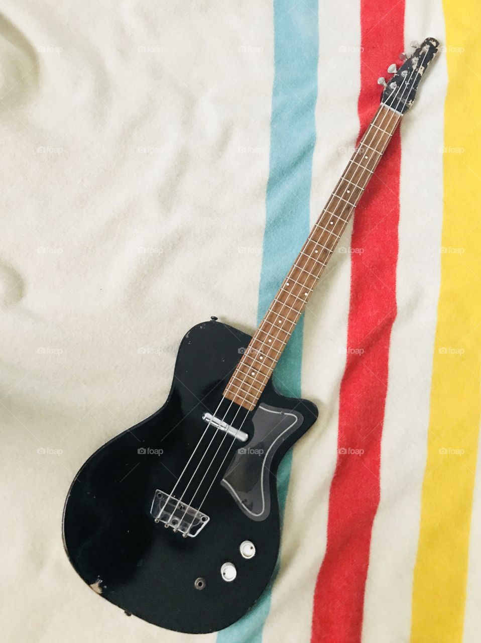 Vintage bass guitar: 1965 Silvertone 1466, Black, on top of a classic retro Hudson’s Bay Company blanket