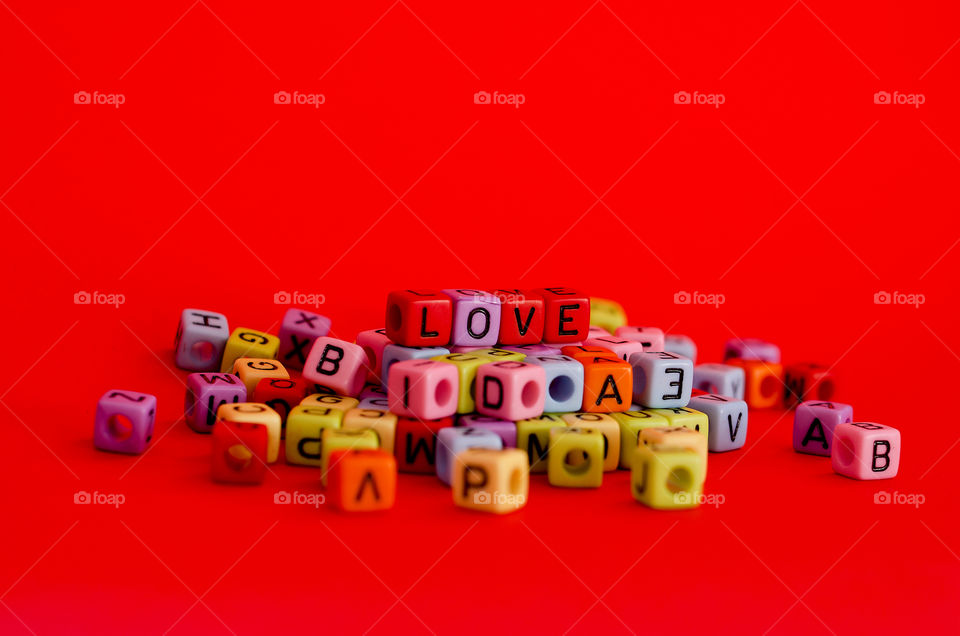 Red background of the words "Love" close up. Valentine day. Flat lay. Top view. Greeting card.