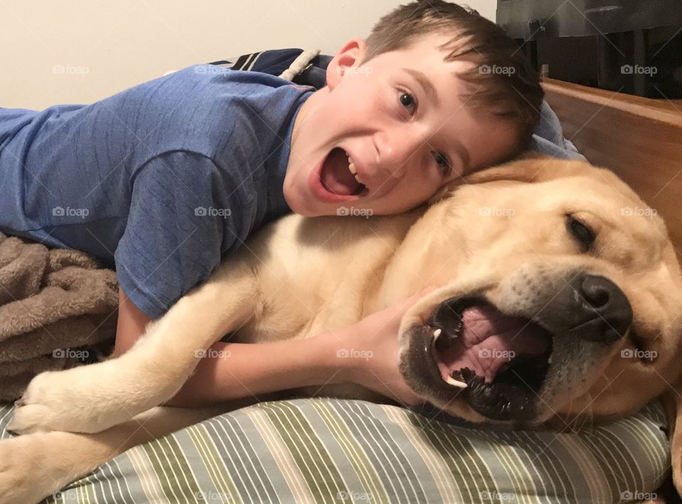 A boy imitating his dog’s expressions 