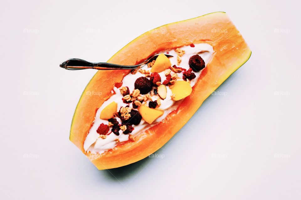 Fruits and nuts served in papaya