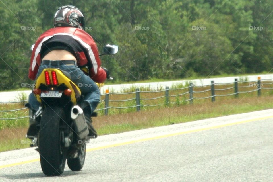 A man driving his bike on the highway
