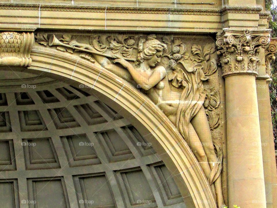 sculpture holding a trumpet