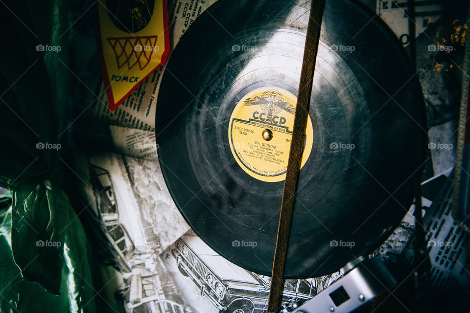 Old vinyls, newspapers and camera on the wall