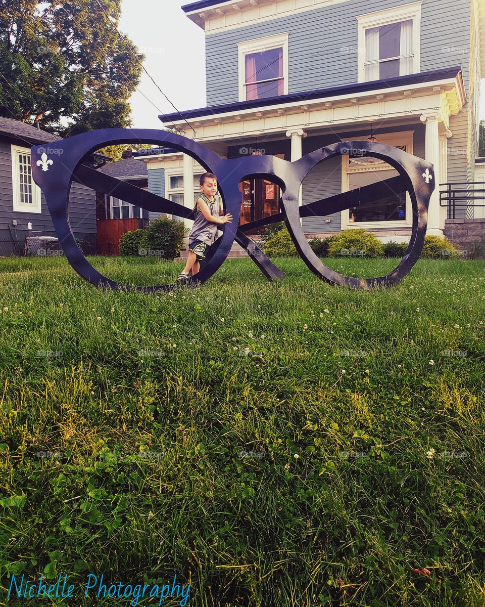 little boy, giant glasses, & grass