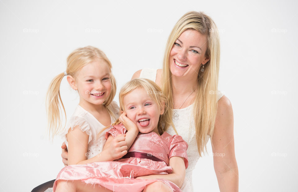 Happy family, mother with her two daughters of 6 and four years old.