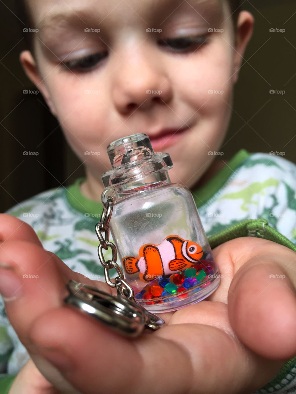 Cute boy holding keychain on hand