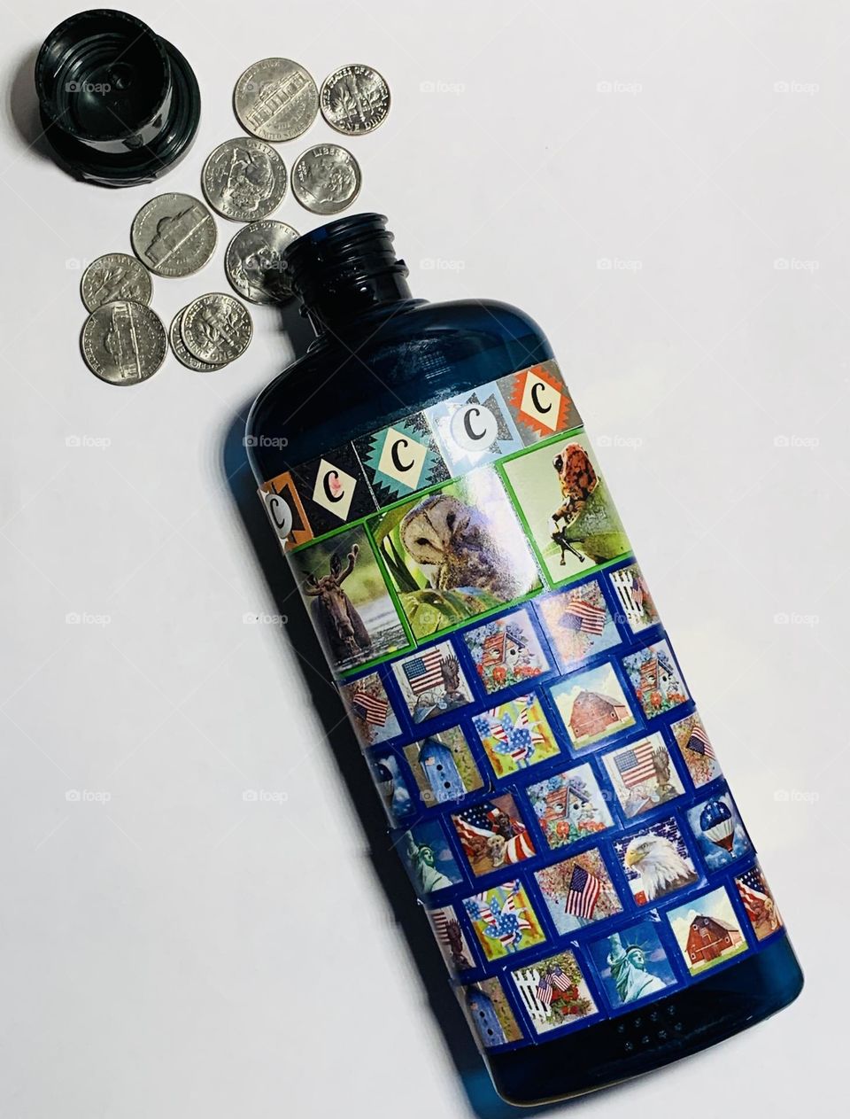 Coin bank using conditioner bottle and stickers on it.