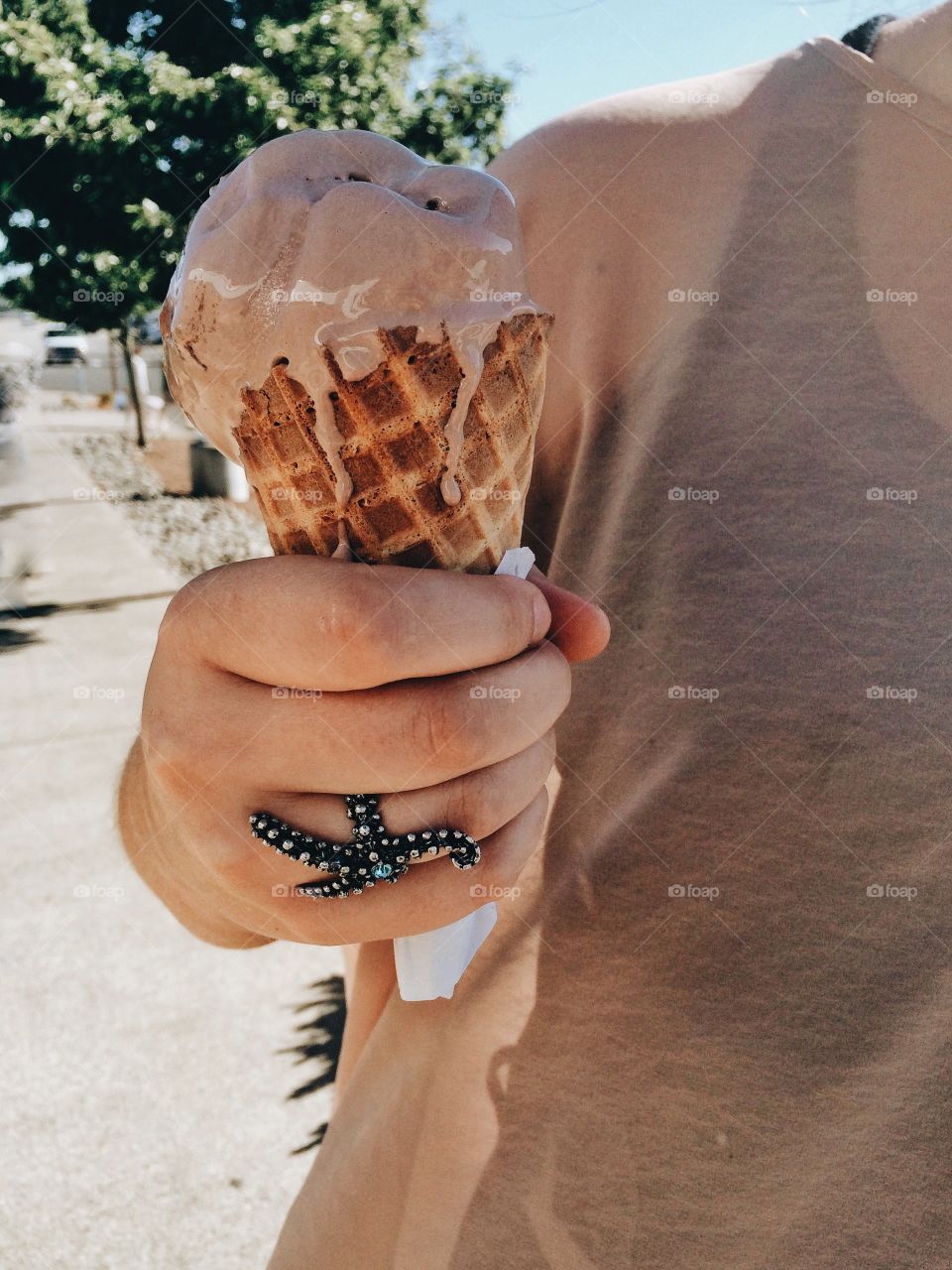 Ice cream melting . Girl holding ice cream cone in summer 