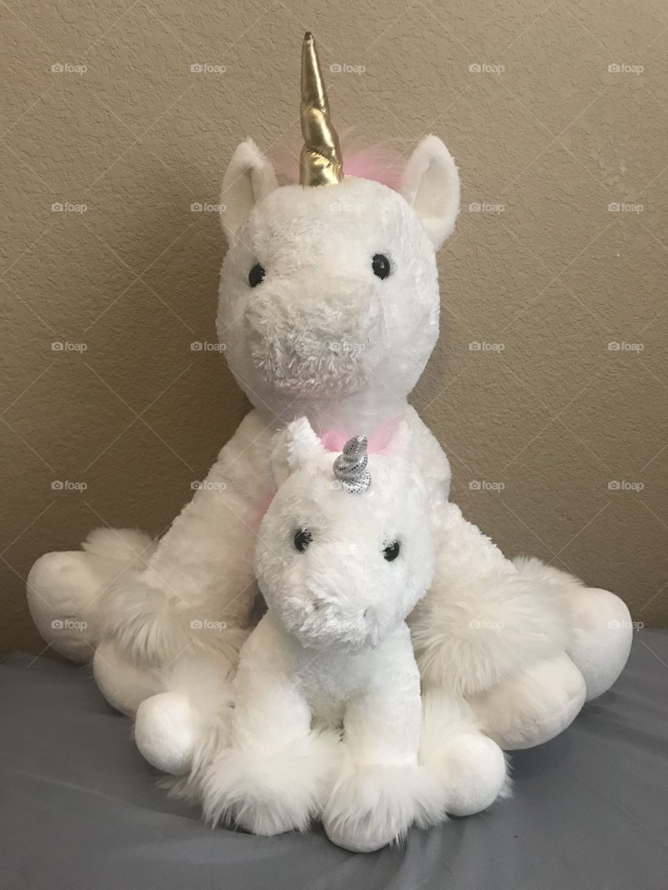 Unicorns with fuzzy pink hair and golden horns 