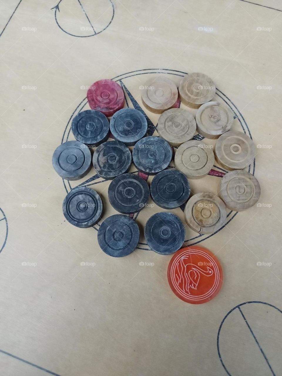 carom board with black red and white colour coins clousup photo in holiday time
