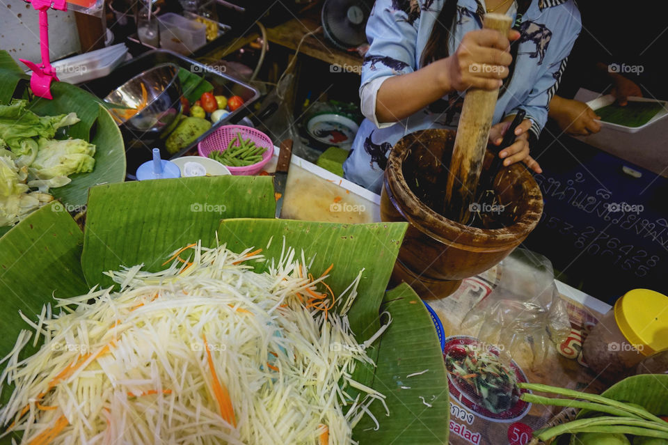 Making green papaya salad at a night market in Chiang Mai, Thailand 