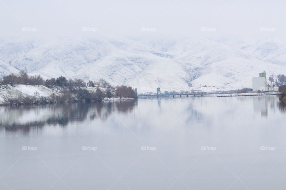 View of snowy mountains in foggy weather