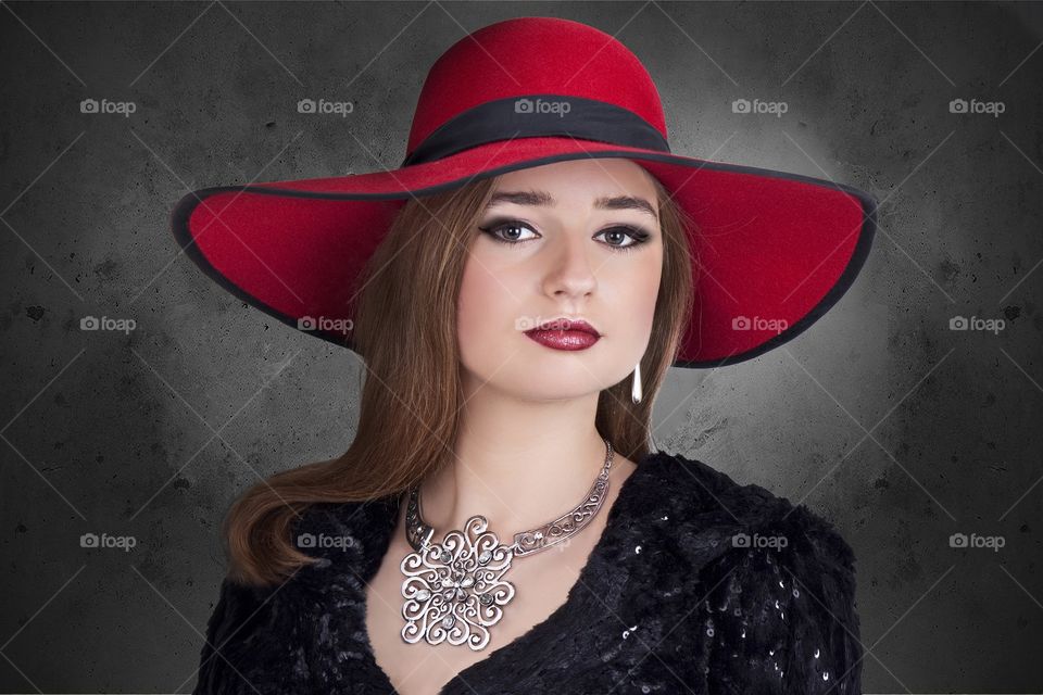 Young woman standing against black background