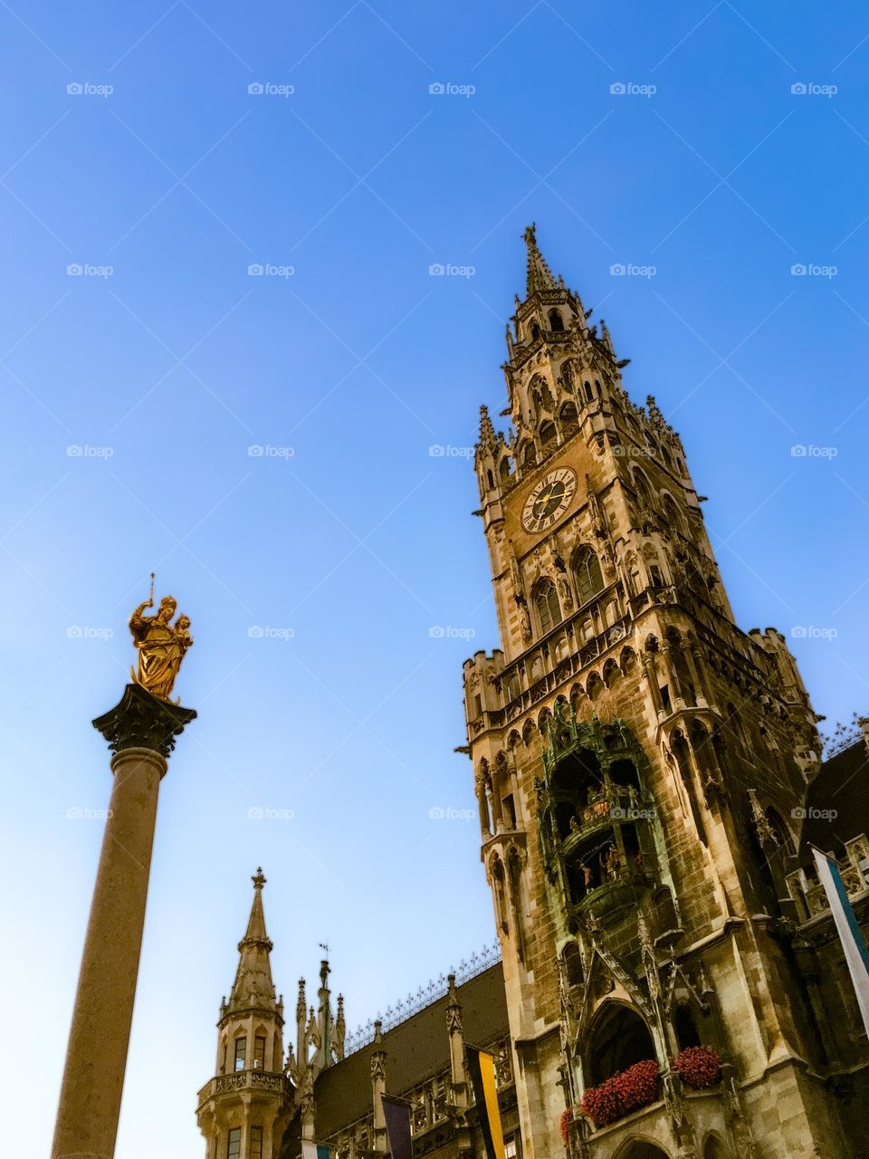 Munich’s bell tower of the new city hall on Marienplatz, seen with the Mariensäule monument. 