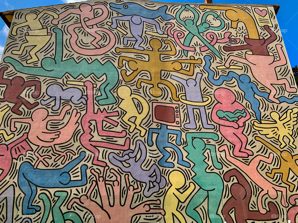 Keith Haring murals in Pisa Italy in the church wall . Pop of color