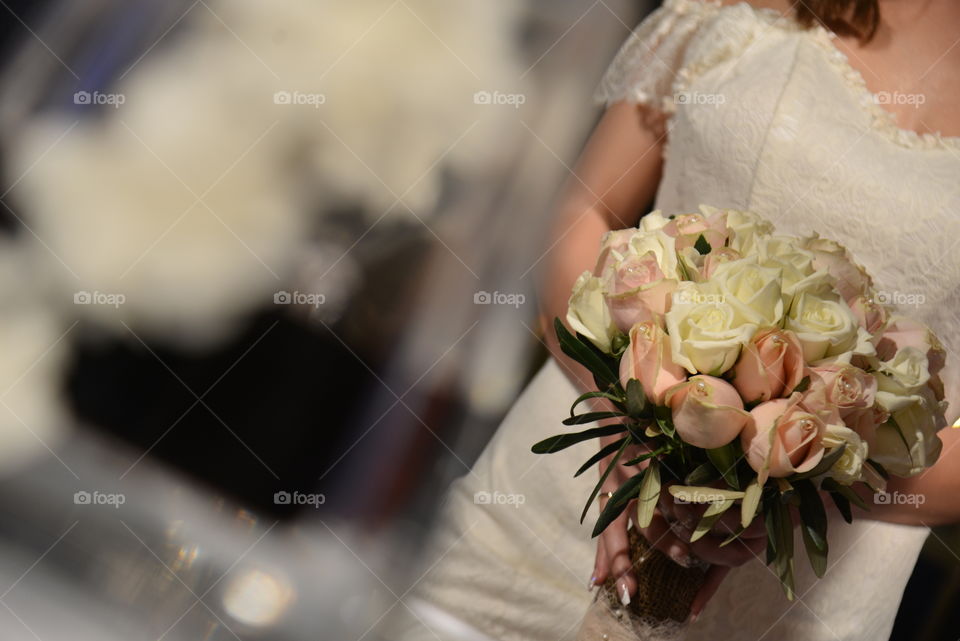 Close-up of bride holding flower bouquet