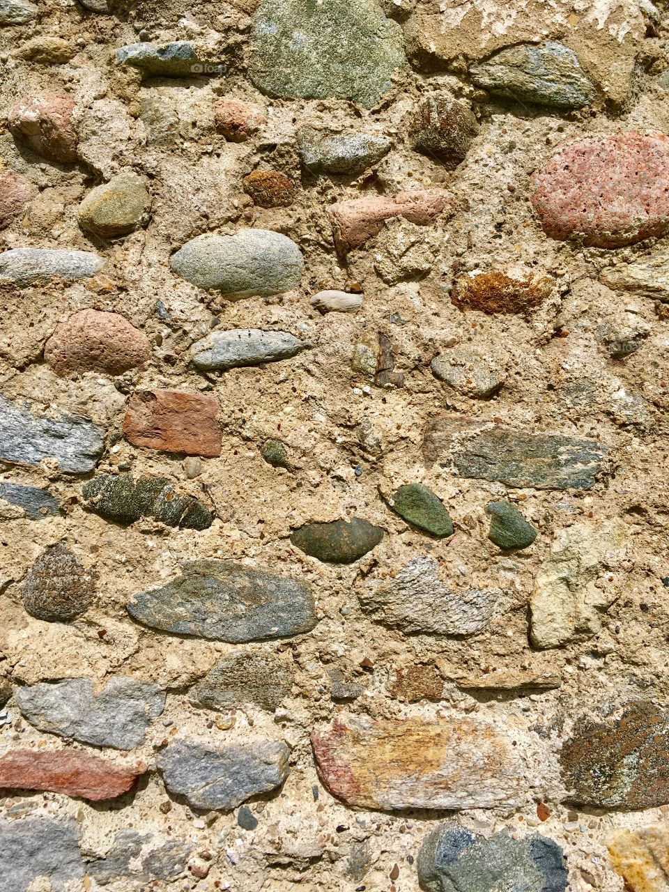 ancient wall of the early Christian basilica of S. Giovanni, archaeological area of Castelseprio, province of Varese. The wall was built with the pebbles of the Olona river, which flows next to it.