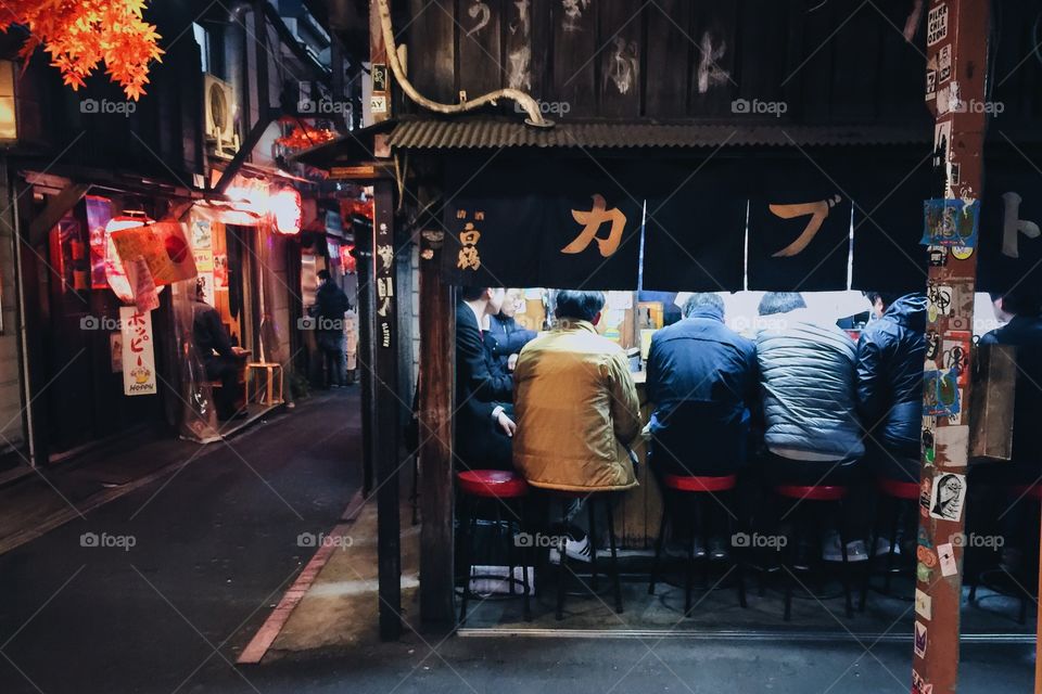 Men drinking in a small Japanese bar