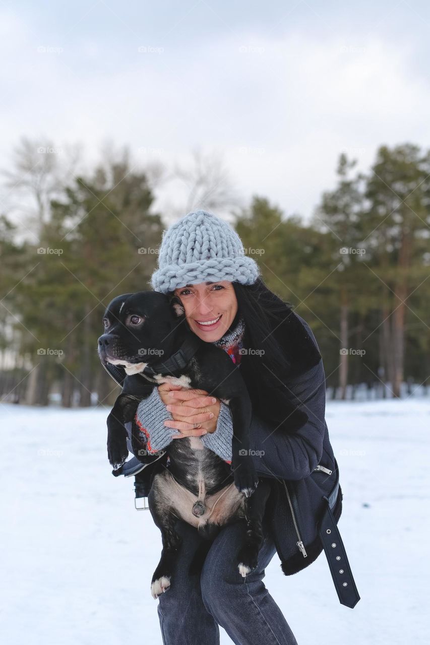 Woman with dog in forest 