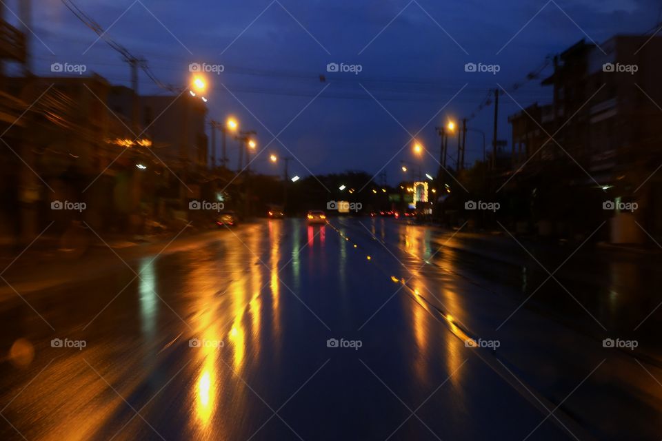 Light reflecting the street at night.