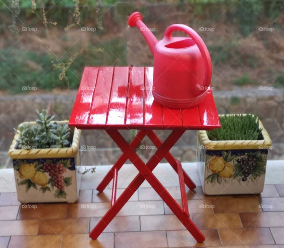 red table and watering can