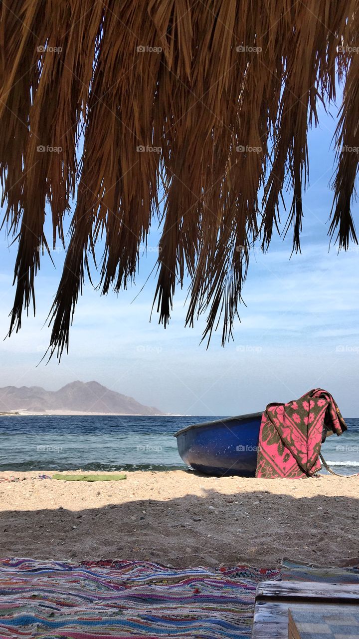 Amazing view of the beach in Ras Shitan, Taba, Egypt with a boat infront 
