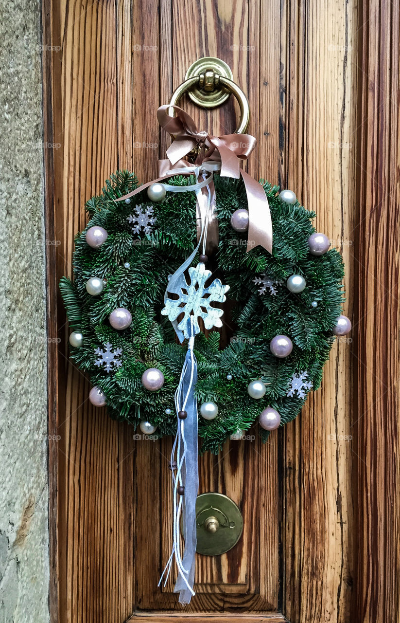 Christmas wreath hanging on the wooden door