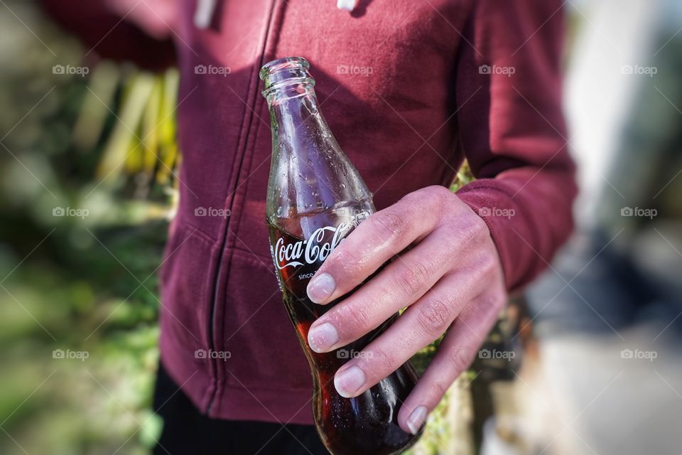 Enjoying a refreshing bottle of Coca Cola 