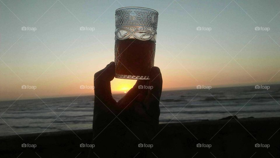 Beautiful cup of tea embraced magic sunset.