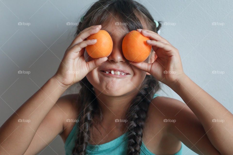 Cute girl with a fresh ripe apricots