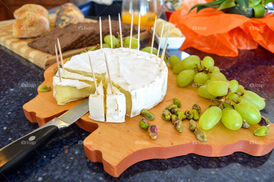 Cheese plate, decorated with grapes.