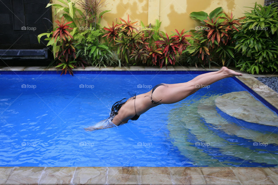Woman diving into swimming pool 