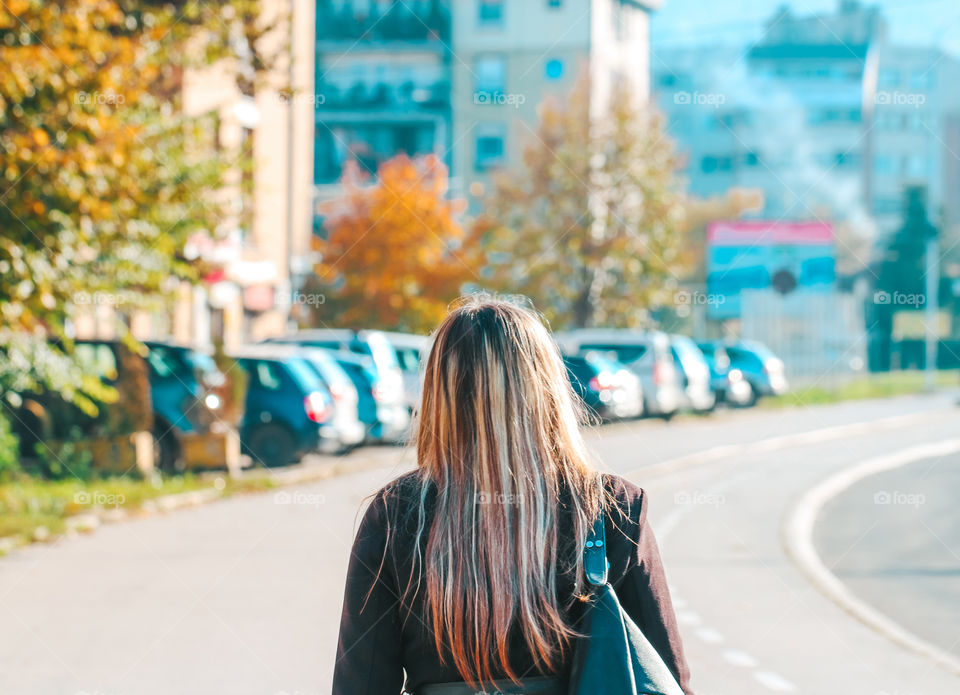 woman walking alone down the street