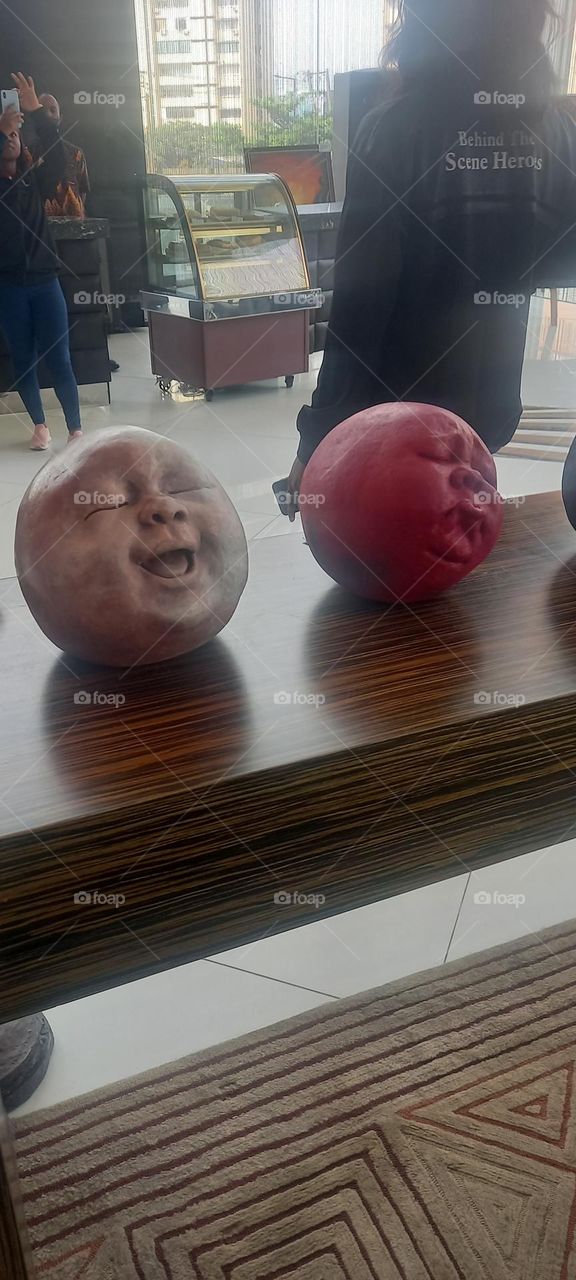 Awesome Art display of round clay faces with various expressions