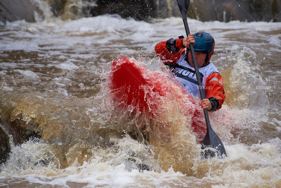 Helsinki, Finland - April 15, 2018: Unidentified racer at the annual Icebreak 2018 whitewater kayaking competition at the Vanhankaupunginkoski rapids in Helsinki, Finland.