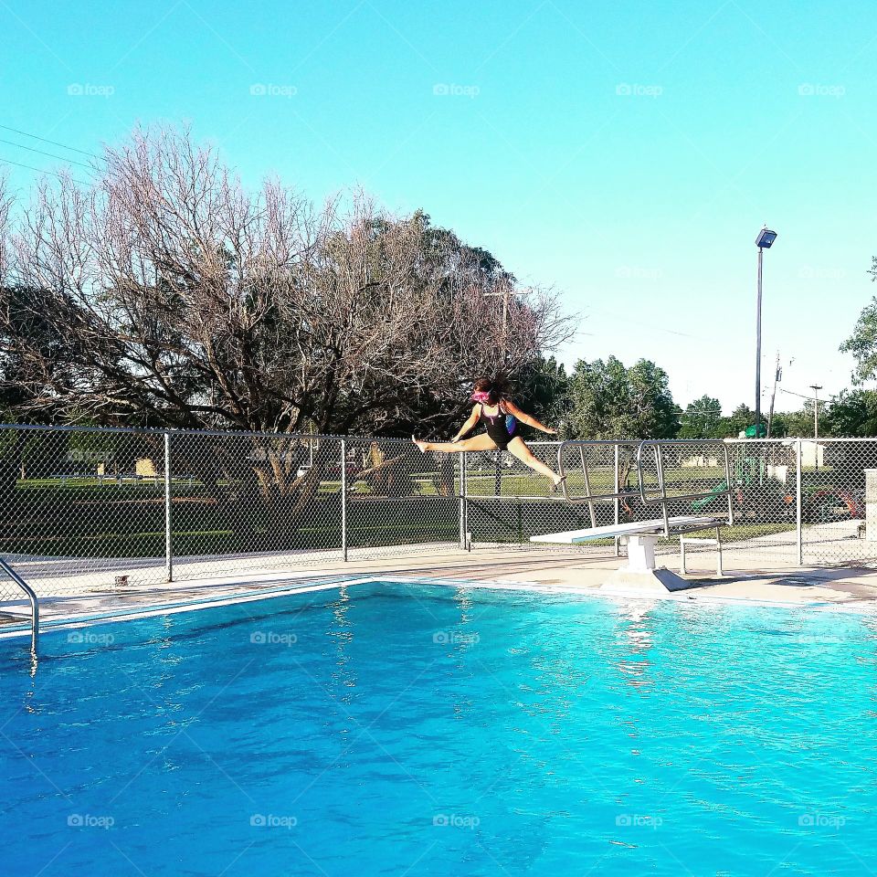 my kid jumping off the diving board. she's been learning new tricks this year!