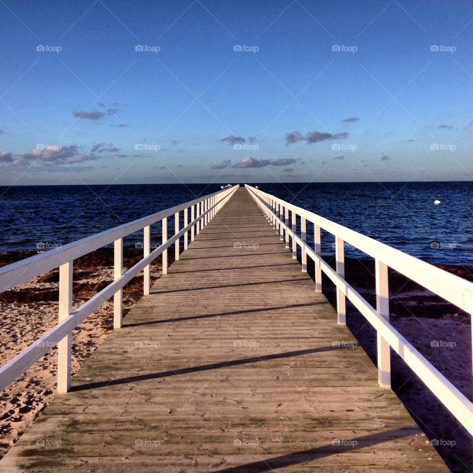 Empty bridge against blue sky