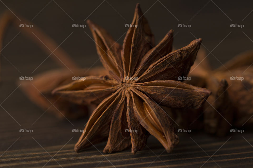 close up of the anise star,  macro shot.  dark mood,  spicy concept