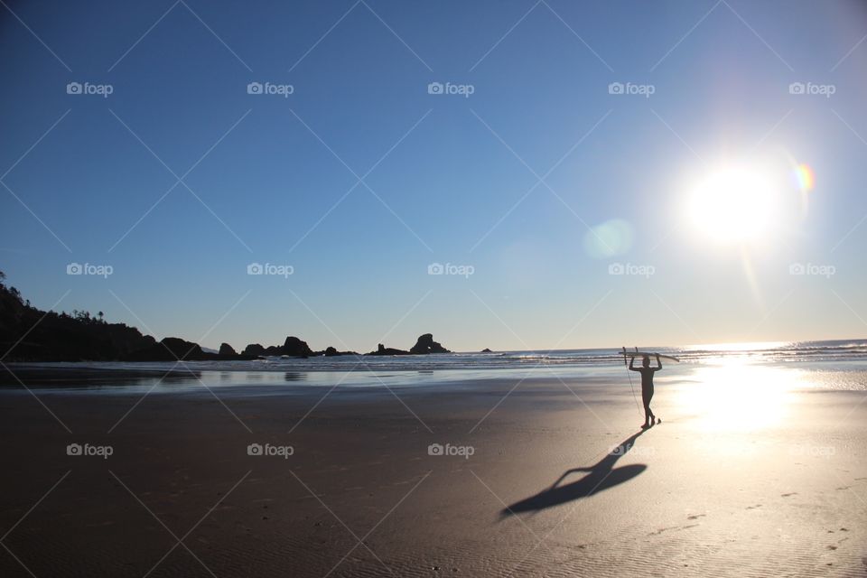 Surfer stepping out of the sun 