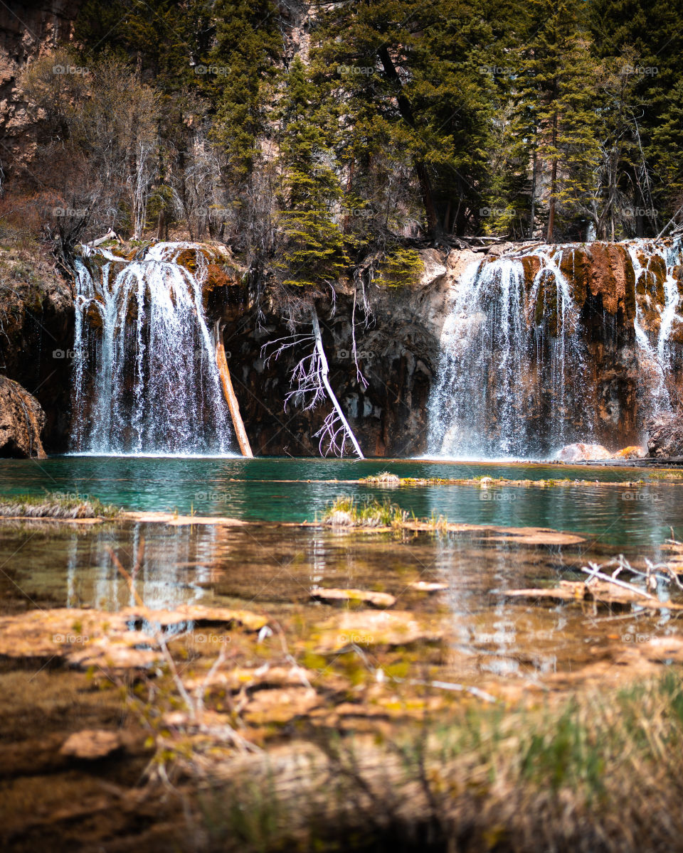 Beautiful crystal clear water flowing from a waterfall into a Colorado lake high in the mountains. 