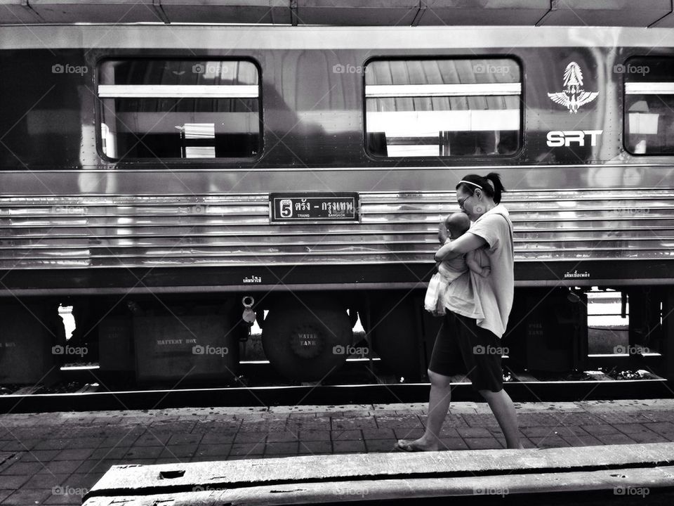 Mother and baby in front of Thai train