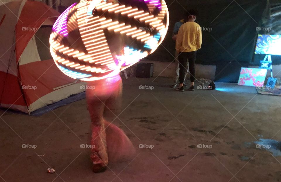 Some lovely ladies twirling around a light up hoola hoop at a rave in Oakland California.