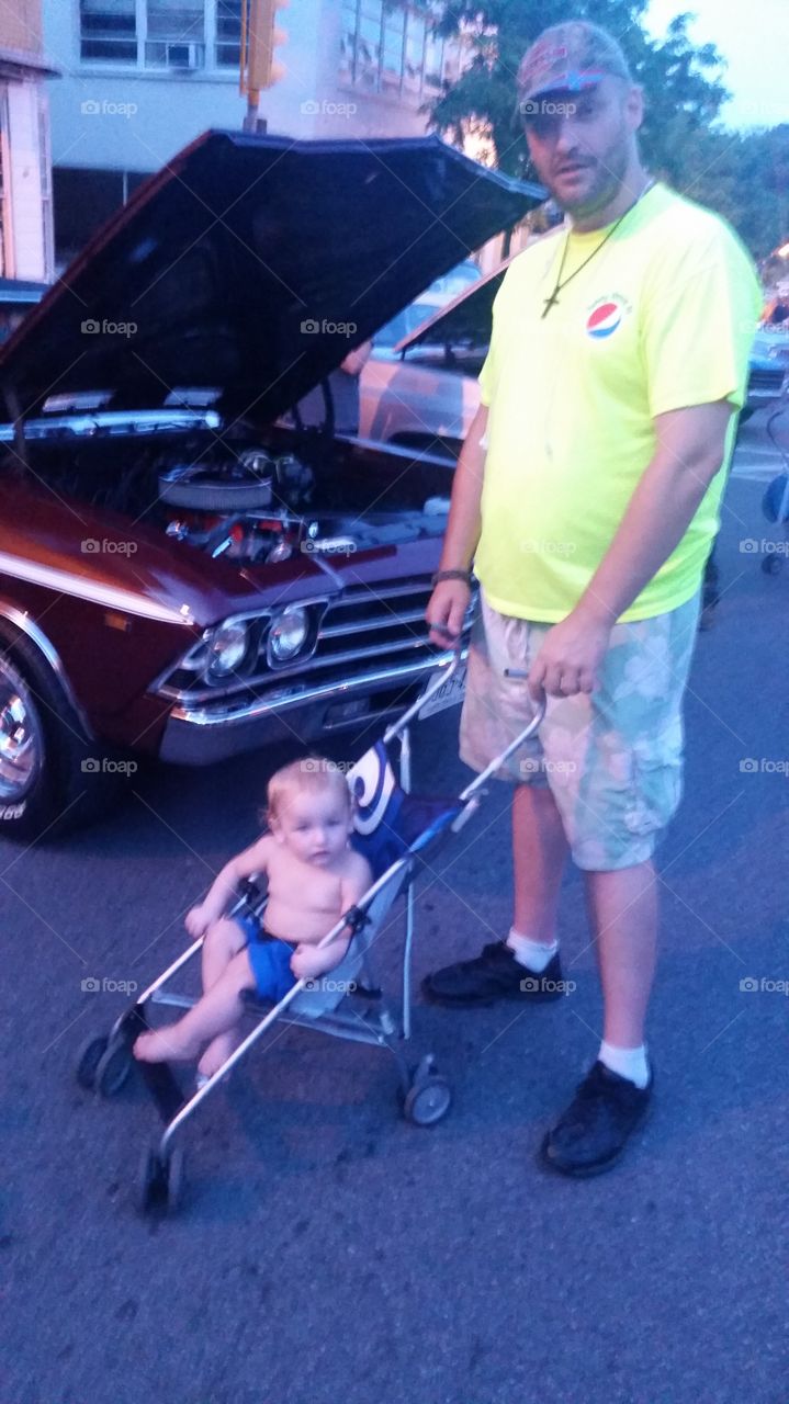 good cars enjoyed by all ages. father and son enjoy the classic cars together