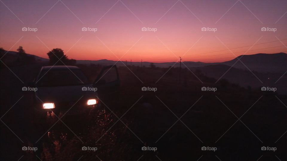 Car lights in the darkness of the sunset