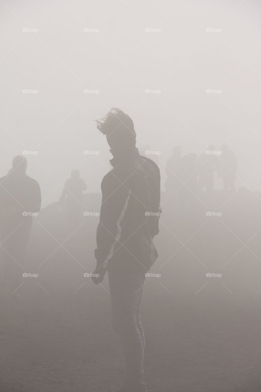Tourists on Mount Etna during foggy weather