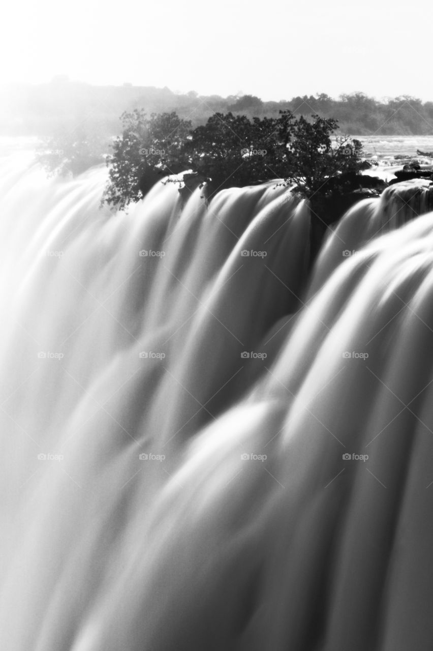 Waterfall black and white image with slow shutter giving soft effect. Taken at Victoria Falls Zimbabwe