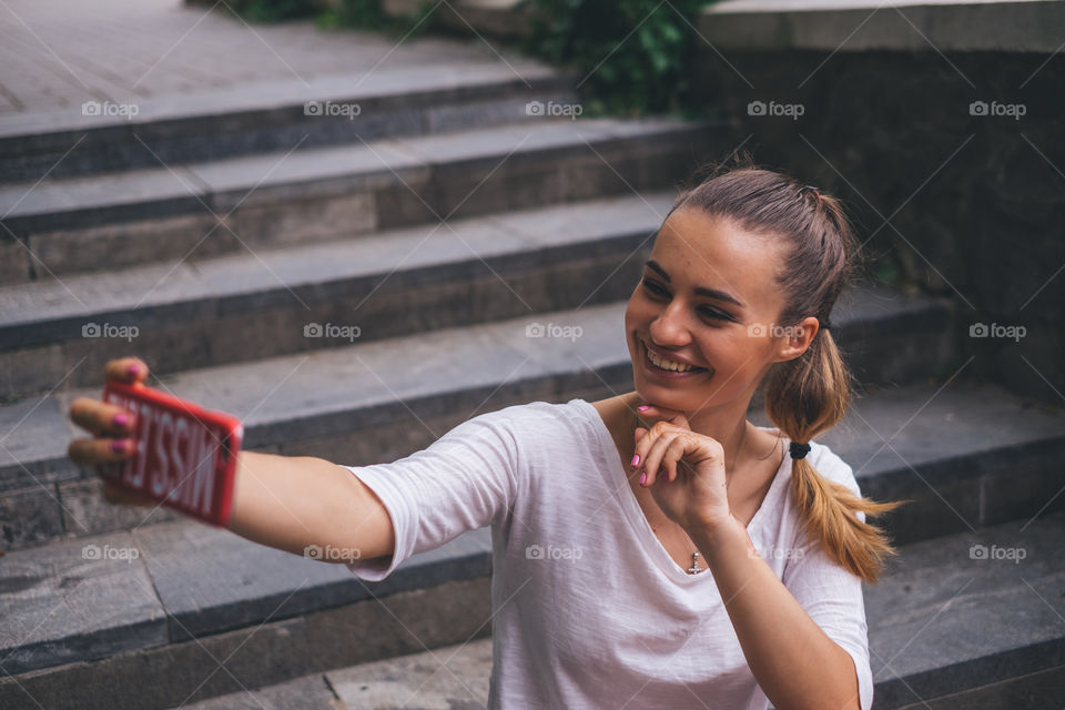 Smiling woman doing selfie