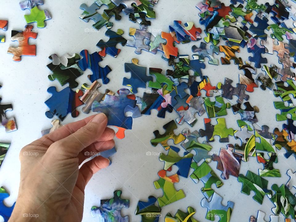 Jigsaw puzzle in human hand